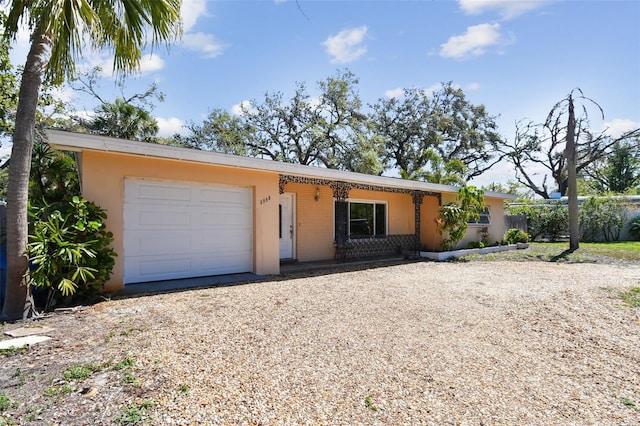 single story home with stucco siding, driveway, and a garage