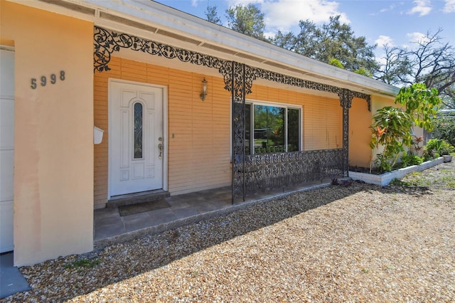 doorway to property featuring a porch