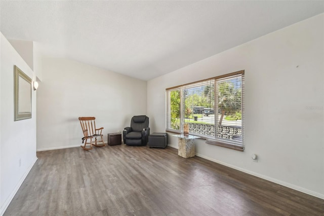 unfurnished room featuring baseboards and wood finished floors