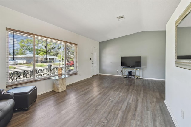 unfurnished living room featuring visible vents, baseboards, lofted ceiling, and wood finished floors