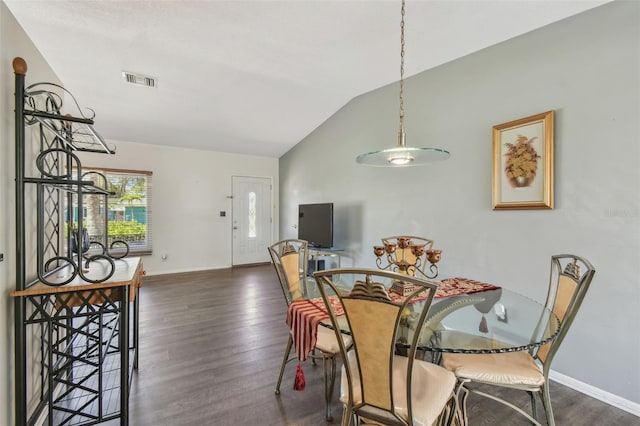 dining space with vaulted ceiling, wood finished floors, visible vents, and baseboards