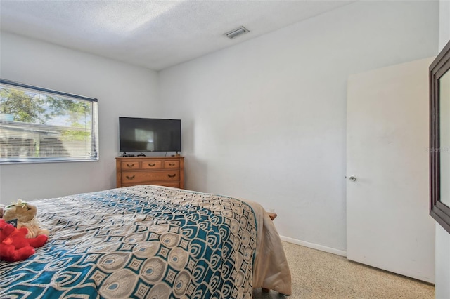 bedroom with visible vents, baseboards, and a textured ceiling