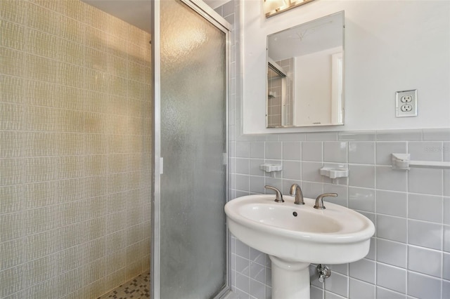 full bathroom featuring tile walls and a stall shower