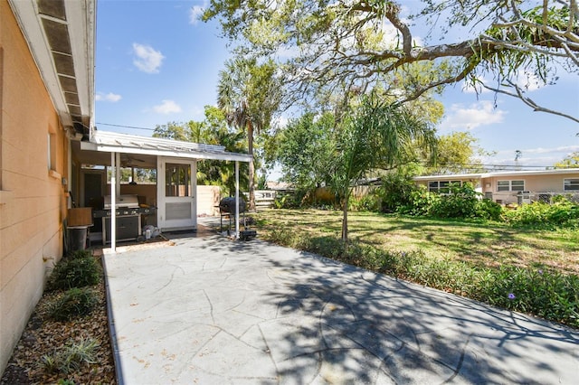 view of patio / terrace with grilling area and fence