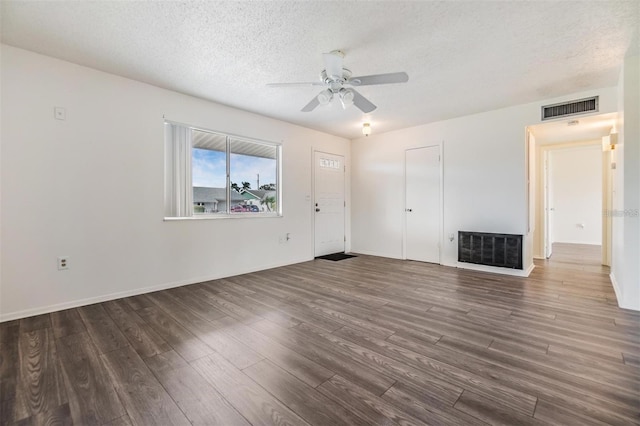 unfurnished living room featuring ceiling fan, visible vents, a textured ceiling, and wood finished floors