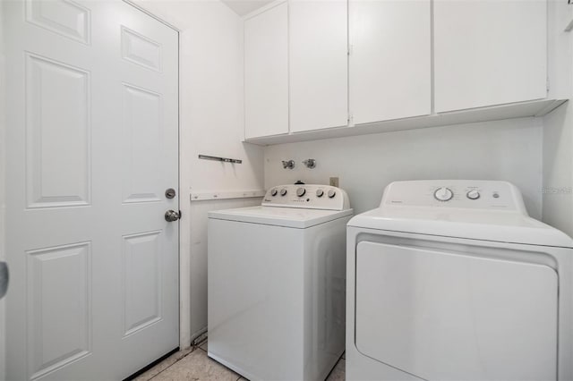 laundry area with cabinet space and washer and clothes dryer