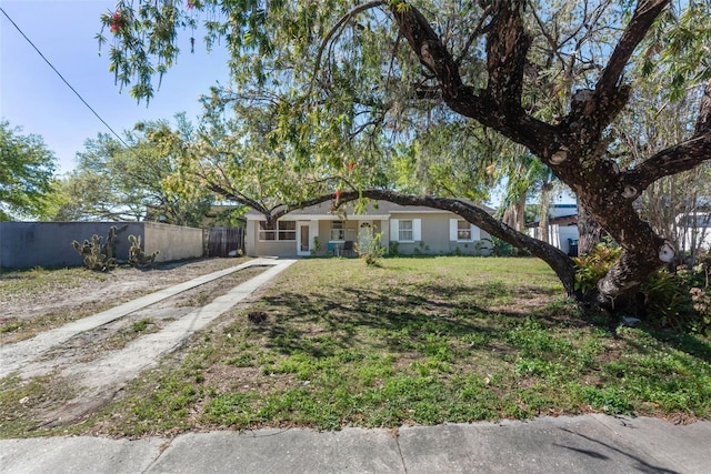 ranch-style house with a front lawn and fence