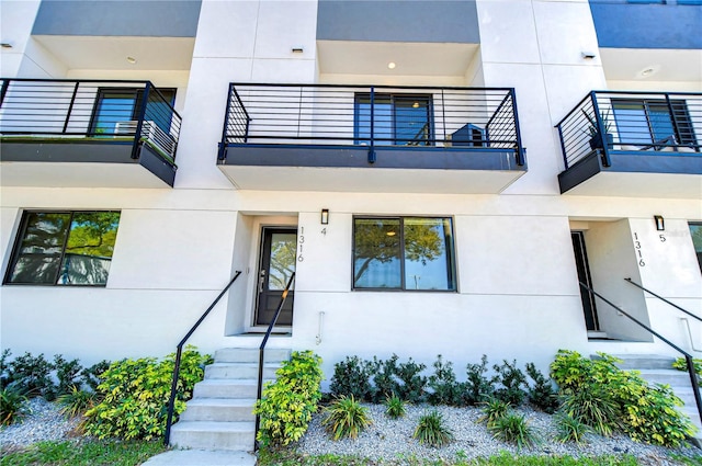 exterior space featuring stucco siding and a balcony