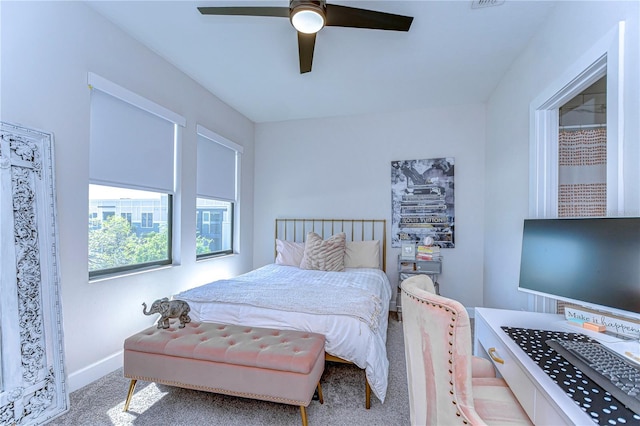 bedroom with a ceiling fan, baseboards, and carpet floors