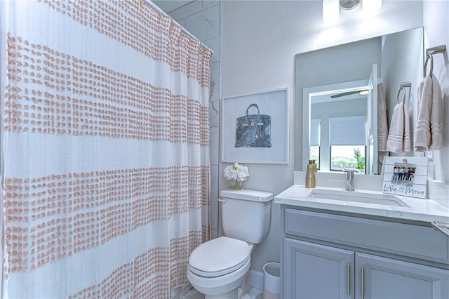 full bathroom with vanity, a shower with shower curtain, and toilet