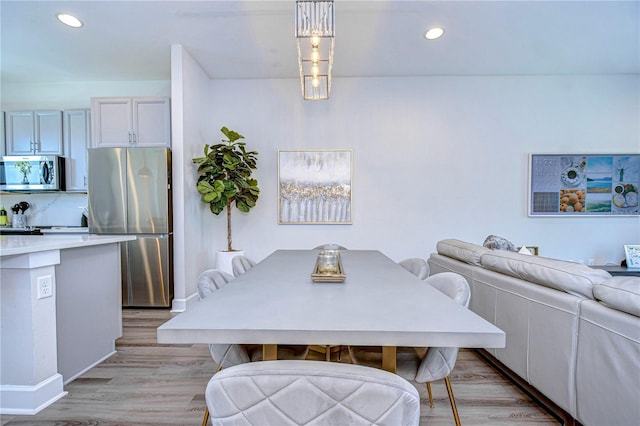 dining area with recessed lighting, baseboards, and light wood-style flooring