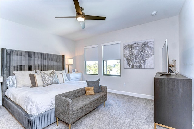 carpeted bedroom with baseboards and a ceiling fan