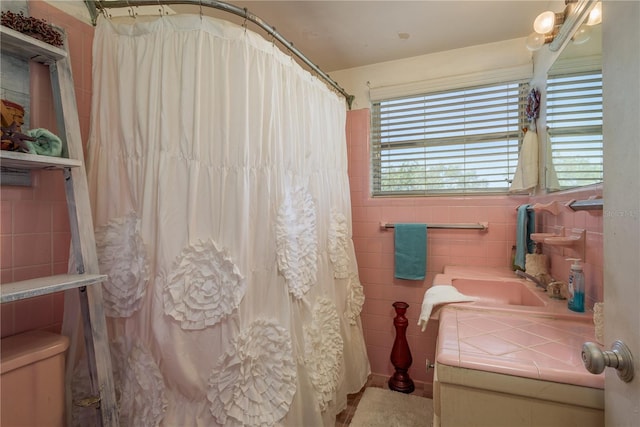 bathroom with vanity, tile walls, and curtained shower