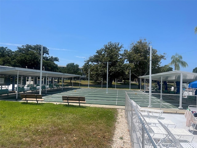 view of property's community featuring a lawn and shuffleboard