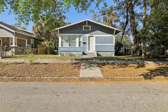 bungalow-style house featuring fence