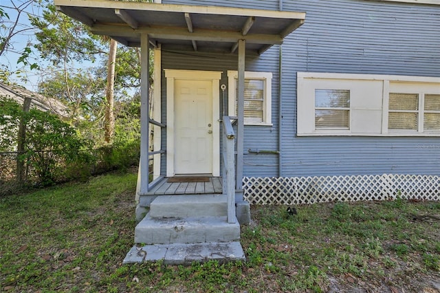 doorway to property featuring fence