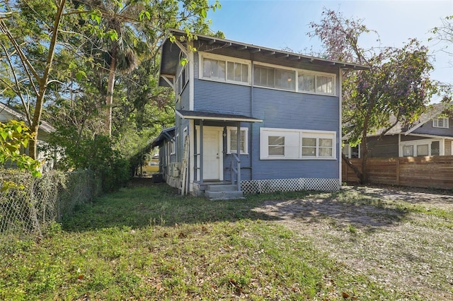 view of front of house with entry steps and a fenced backyard