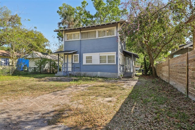 back of property featuring fence