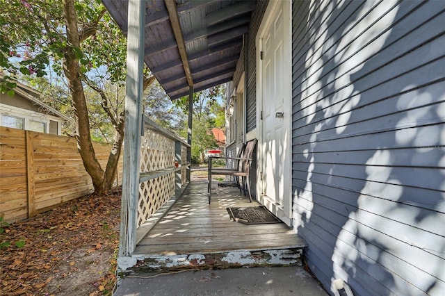 wooden terrace featuring fence