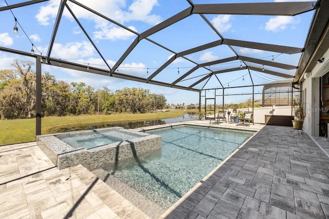 view of pool featuring glass enclosure, a patio area, a water view, and a pool with connected hot tub