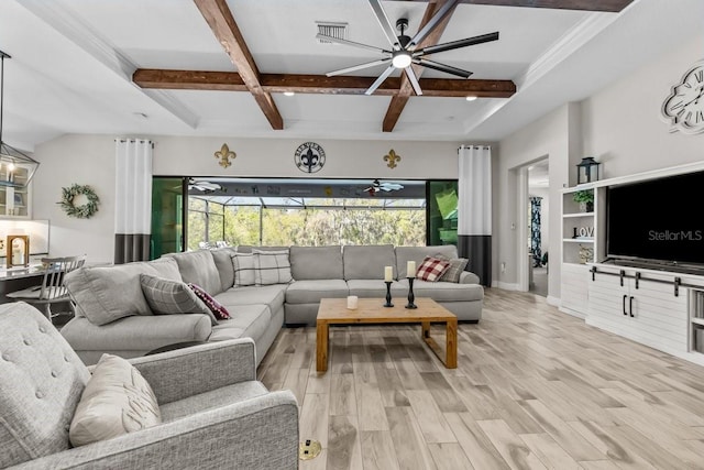 living area with a wealth of natural light, beamed ceiling, a ceiling fan, and light wood finished floors