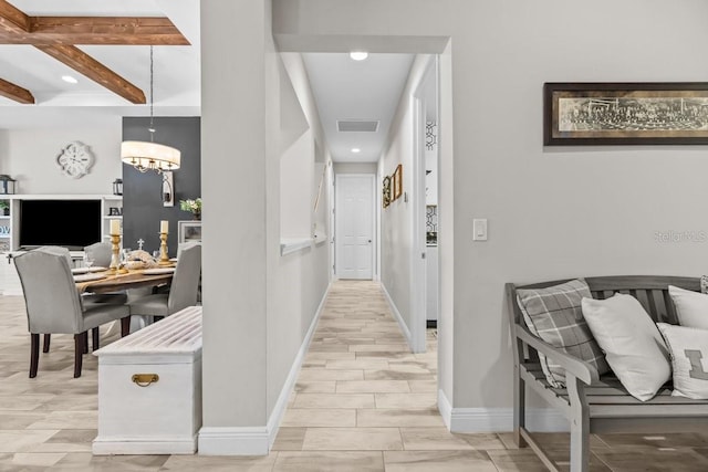 hallway with visible vents, baseboards, a chandelier, beamed ceiling, and recessed lighting