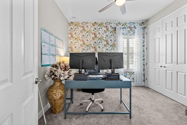 home office featuring carpet flooring, wallpapered walls, baseboards, and a ceiling fan