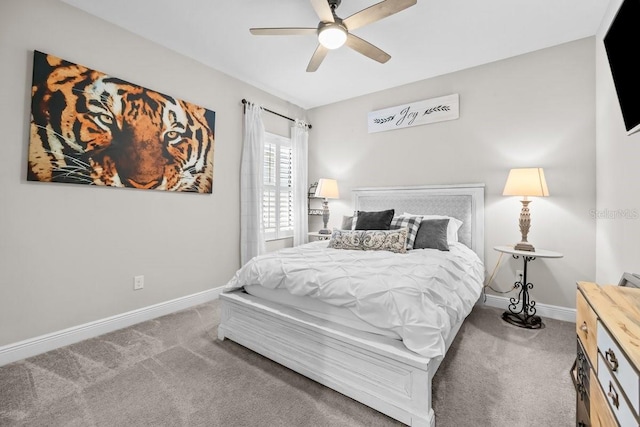 carpeted bedroom with ceiling fan and baseboards