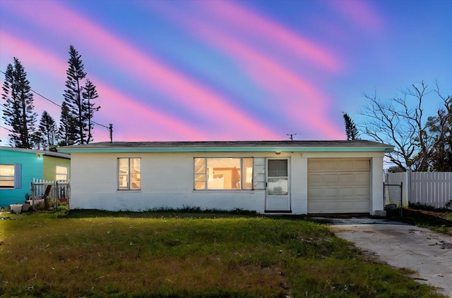 ranch-style house featuring driveway, a garage, and fence