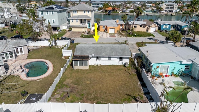 drone / aerial view with a residential view and a water view