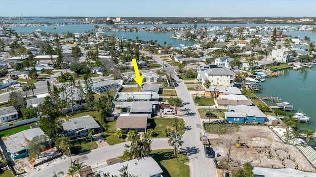 drone / aerial view featuring a residential view and a water view