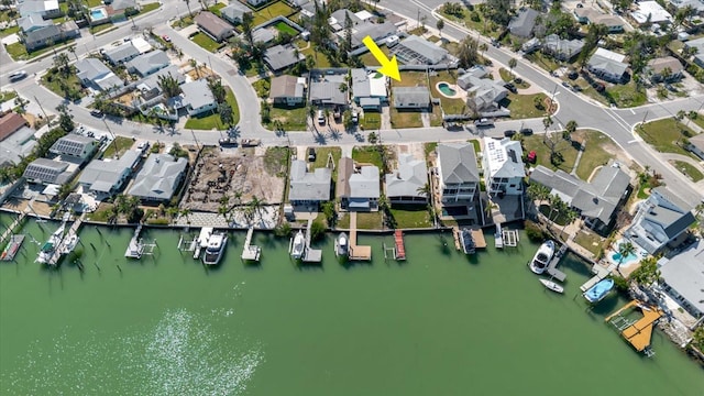 drone / aerial view featuring a residential view and a water view