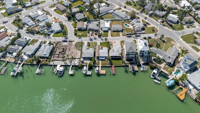 drone / aerial view featuring a residential view and a water view