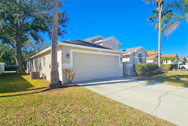 view of front of property with a front yard, cooling unit, stucco siding, concrete driveway, and a garage