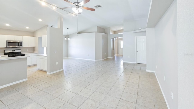 kitchen with visible vents, arched walkways, stainless steel appliances, vaulted ceiling, and open floor plan