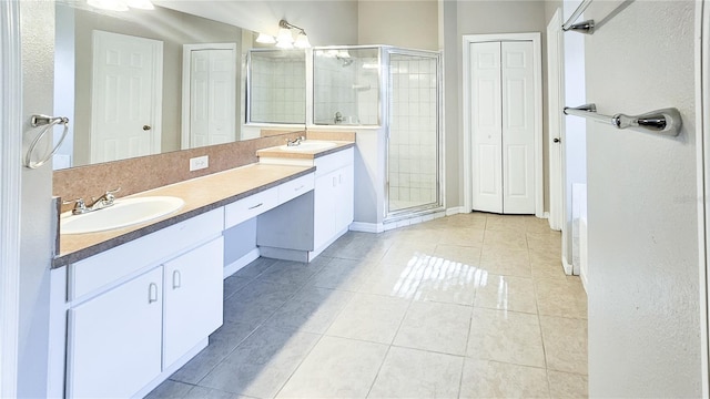 bathroom with a sink, a stall shower, and tile patterned flooring