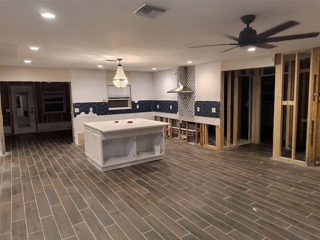 kitchen featuring white cabinetry, light countertops, open shelves, dark wood-type flooring, and wall chimney range hood