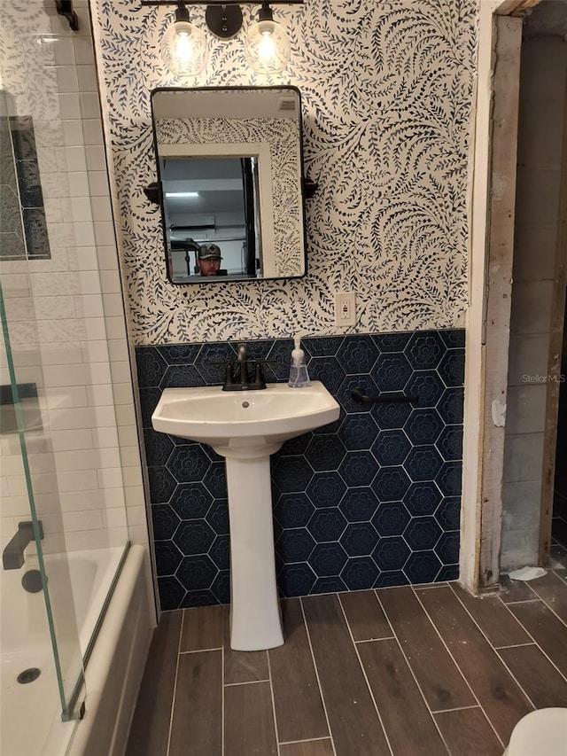 bathroom featuring tile walls and wood finish floors