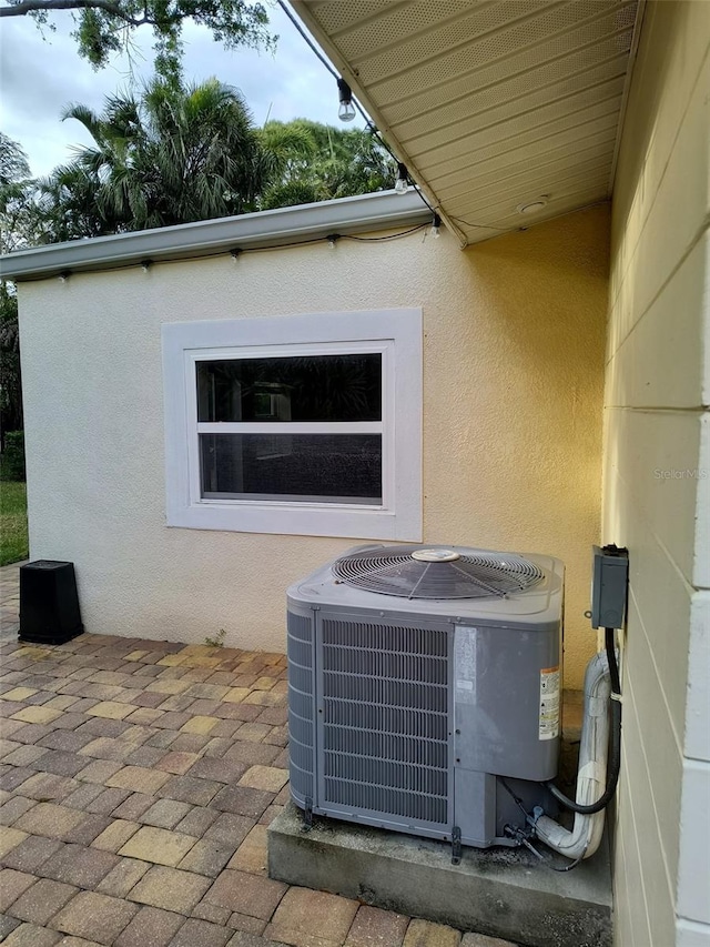 details with cooling unit and stucco siding