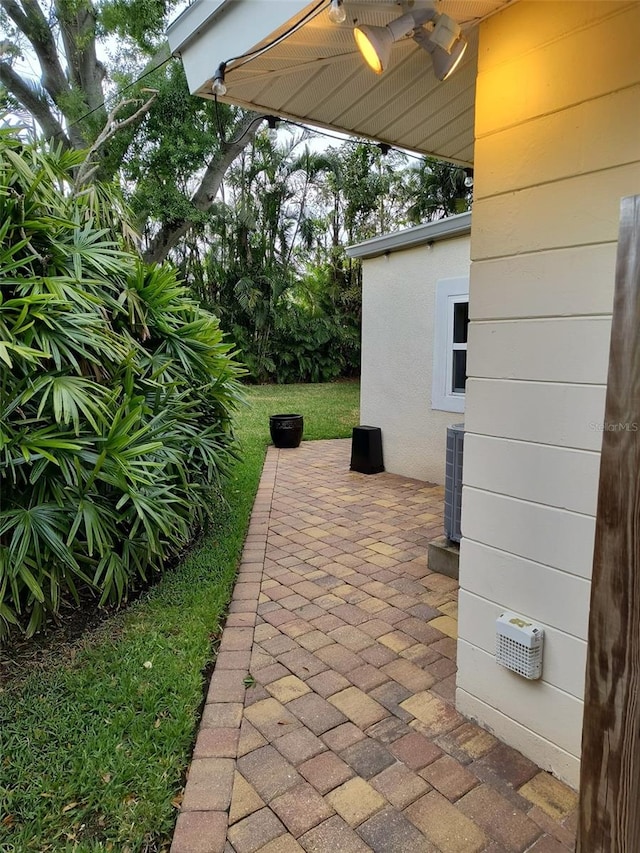 view of patio / terrace featuring a ceiling fan and central AC unit