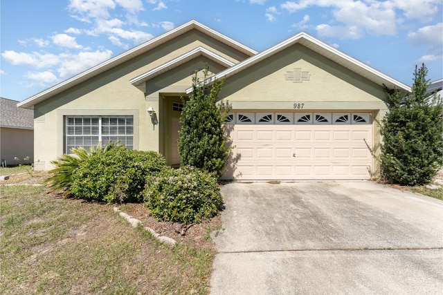 ranch-style home featuring stucco siding, concrete driveway, and an attached garage