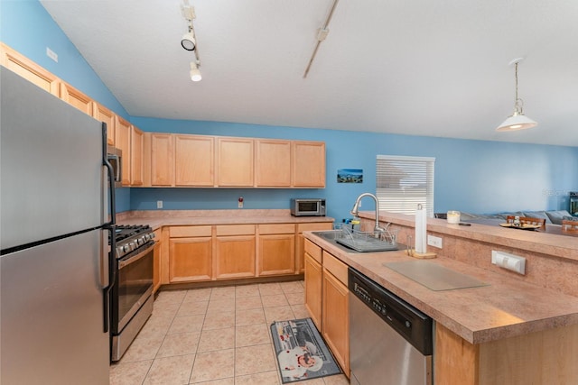 kitchen with light brown cabinets, light countertops, light tile patterned floors, appliances with stainless steel finishes, and a sink