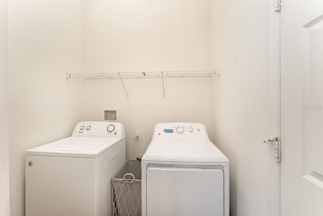 washroom featuring laundry area and washing machine and dryer