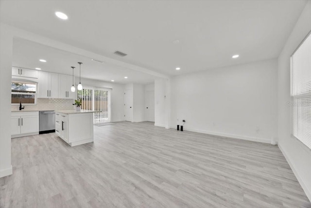 2415 Sutton Rd, Lakeland, FL 33810 - kitchen featuring stainless steel dishwasher, open floor plan, recessed lighting, white cabinets, and light countertops