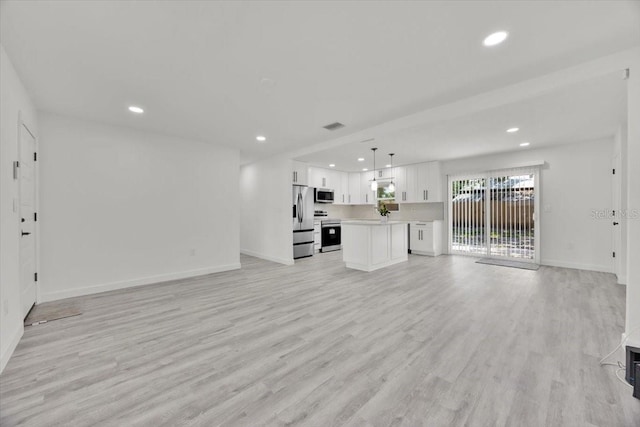 2415 Sutton Rd, Lakeland, FL 33810 - unfurnished living room with recessed lighting, light wood-type flooring, and baseboards