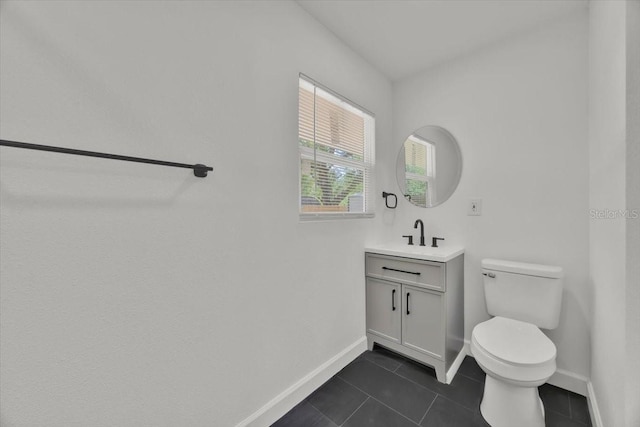 2415 Sutton Rd, Lakeland, FL 33810 - bathroom with baseboards, tile patterned flooring, toilet, and vanity
