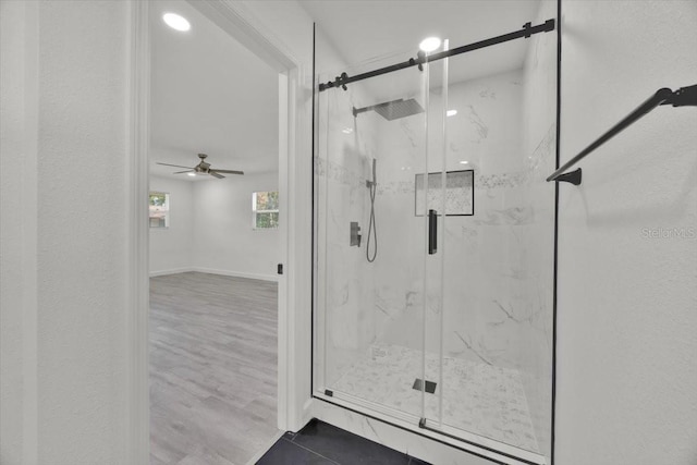 2415 Sutton Rd, Lakeland, FL 33810 - bathroom featuring a ceiling fan, a marble finish shower, and tile patterned floors