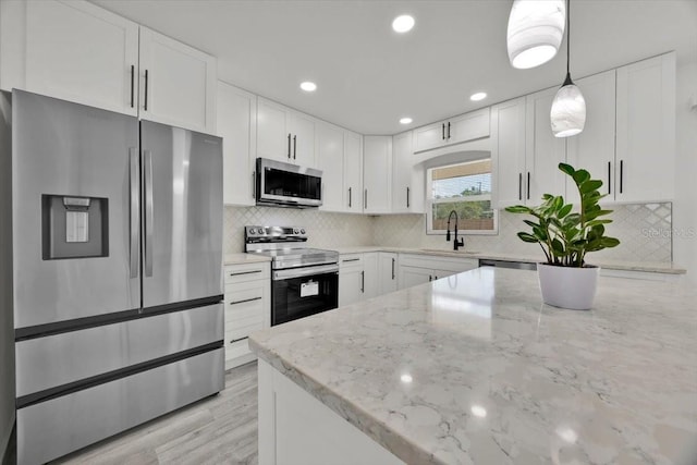 2415 Sutton Rd, Lakeland, FL 33810 - kitchen with appliances with stainless steel finishes, a sink, white cabinetry, and recessed lighting