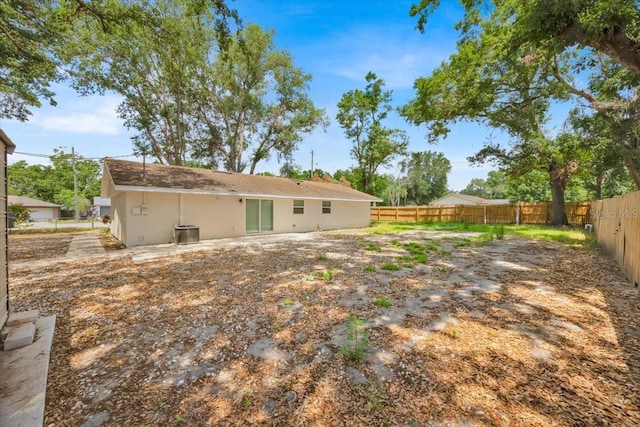 2415 Sutton Rd, Lakeland, FL 33810 - rear view of house with a fenced backyard and central AC