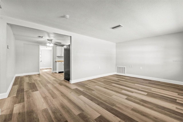 unfurnished room featuring visible vents, baseboards, and light wood-style floors